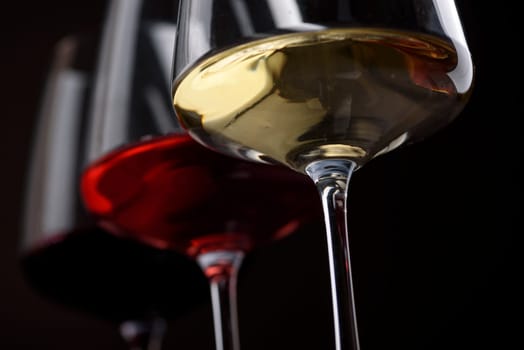 Closeup of three glass of red, rose and white wine over black background. Wine card menu design. Wine list still life.