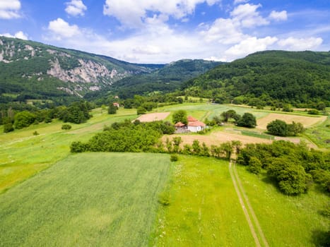 Aerial view of mountain green landscape. Highland hills and meadows form above.