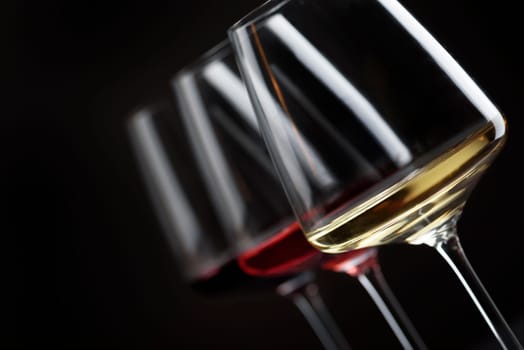 Three glass of red, rose and white wine over black background. Wine card menu design.