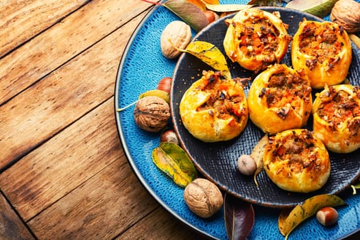 Autumn homemade pastries.Fresh buns with minced meat and pumpkin.
