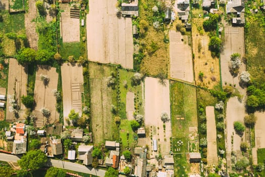 Russia. Aerial View Of Small Town, Village Cityscape Skyline In Summer Day. Residential District, Houses And Vegetable Garden Beds In Bird's-eye View.