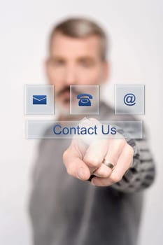 Senior man pressing contact button on virtual screen
