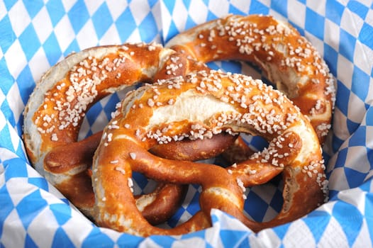 Three original Bavarian lye pretzels with salt on Bavarian diamond pattern