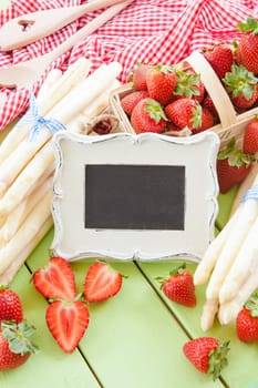 Fresh white asparagus and ripe red strawberries