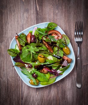 Mixed low calorie salad with olives and fresh avocado