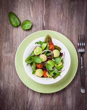 Spring mixed salad with avocado, olives and herbs