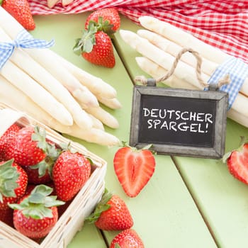 Fresh white asparagus and ripe red strawberries
