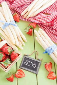 Fresh white asparagus and ripe red strawberries