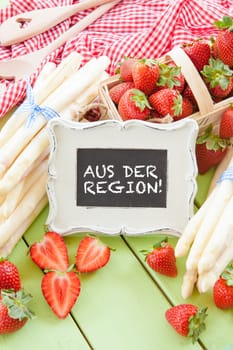 Fresh white asparagus and ripe red strawberries