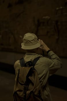 Rear view of a man taking photos from underground emboss