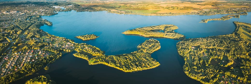 Lyepyel, Lepel Lake, Beloozerny District, Vitebsk Region. Aerial View Of Lyepyel Cityscape Skyline In Autumn Morning. Morning Fog Above Lepel Lake. Top View Of European Nature From High Attitude In Autumn. Bird's Eye View. Panormic View.
