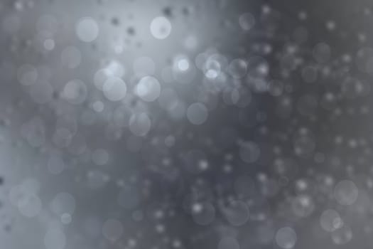 Abstract festive gradient light blue gray silver bokeh background texture with white bokeh lights. Beautiful backdrop with space for christmas, invitation or other holidays.