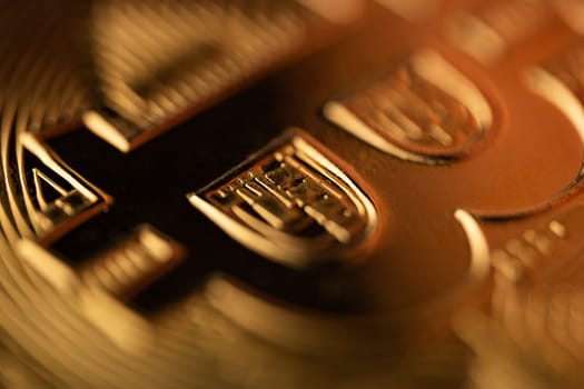 top view extreme macro closeup of of the B letter on crypto bitcoin golden coin logo with shallow depth of field