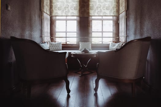 front view of divan with several pillows in front of window