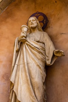 A statue of Jesus Christ with the Holy Grail in a catholic church