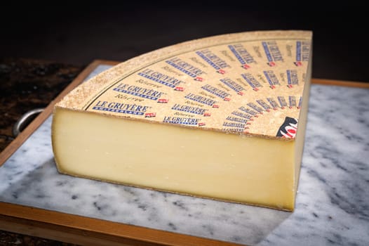 July 11 2022, Lyon, France : Switzerland cheese : Le Gruyère Réserve, famous swiss cheese in a cellar on a marbble background