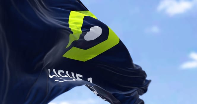Paris, FRA, July 2022: Ligue 1 flag waving in the wind. Ligue 1 is a French professional league for men association football clubs. Illustrative editorial. Selective focus