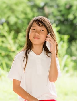 Asia girl use smart phone in garden at summer outdoor