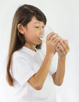 Young girl drinking milk in Studio on white