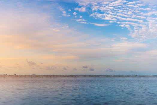 Beach sunset or sunrise with colorful of cloud sky and sunlight in evening light