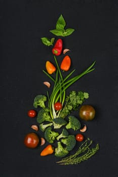 Overhead composition with fresh spring onion, tomato, broccoli, bell pepper, thyme, basil and garlic