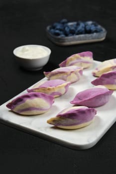 Frozen pierogi with blueberry and sour cream