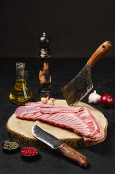 Raw fresh lamb ribs, uncut with spices and herbs on kitchen table