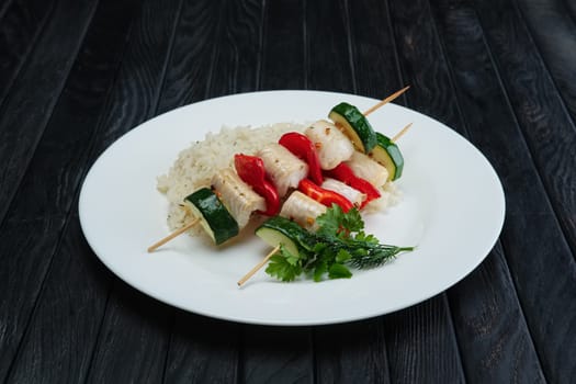 Grilled fish and vegetables on skewer with boiled rice
