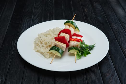 Grilled fish and vegetables on skewer with boiled rice
