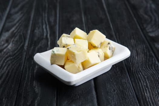 Small square pieces of blue cheese. Cheese with fungus.