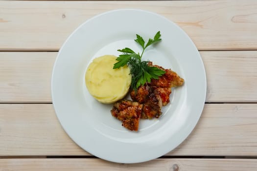 Portion of delicious fried meat in honey sauce with mashed potato. Top view.