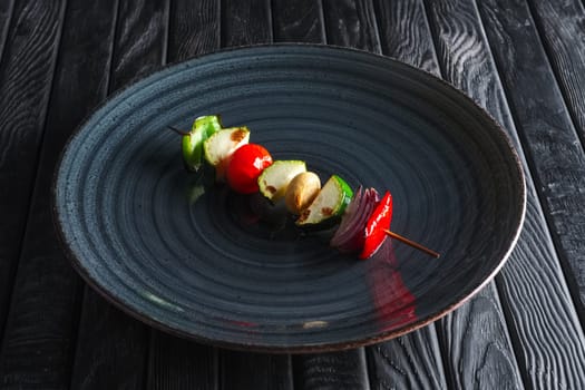 Grilled zucchini, bell pepper, mushroom, tomato and onion on skewer