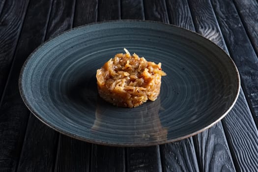 Plate with onion marmalade. Candied onion jelly.
