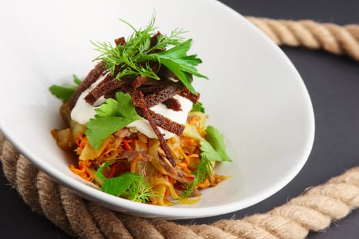 Authentic salad with bean, cabbage and pickled cucumber. Closeup view.