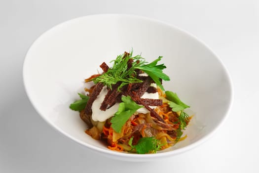 Deep plate of salad with bean, cabbage and pickled cucumber on white background
