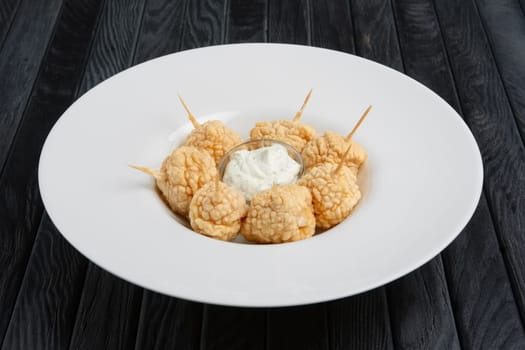 Snack for beer - deep fried cheese balls with sauce