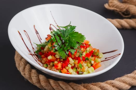 Lenten salad with tomato, marrow squash, cuscus, zucchini and paprika on a plate
