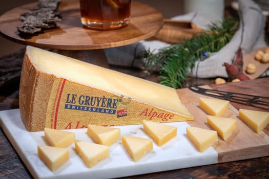 July 12 2022, Lyon, France : Tasted famous swiss cheese : Le Gruyère d'Alpage with milk and honey for lunch and food experience