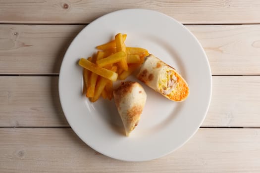 Meat, spicy carrot, cabbage and cheese rolled up in thin pitta bread