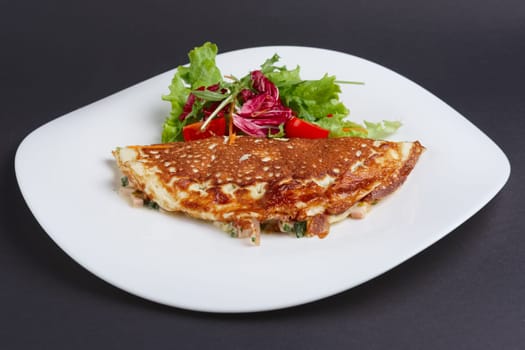 omelet with ham and vegetables on a plate