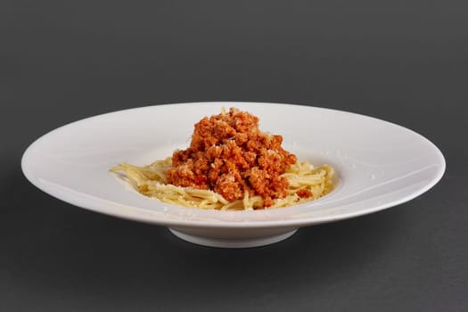 Side view of plate with spaghetti with fried ground-meat