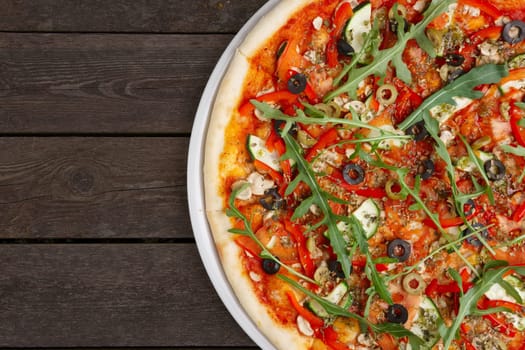 Lean pizza Margherita with cheese, arugula, tomato sauce on a white plate. Your text here.