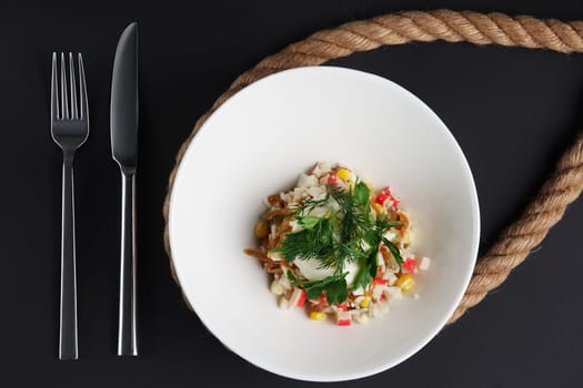Top view of salad with crab, corn and fried onion.