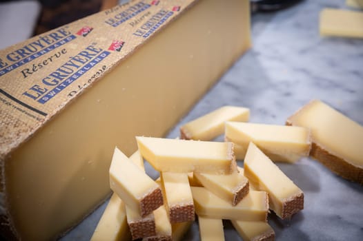 July 11 2022, Lyon, France : Switzerland cheese : Le Gruyère Réserve, famous swiss cheese in a cellar on a marbble background