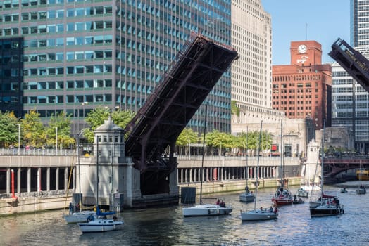 CHICAGO, ILLINOIS/USA-OCTOBRE 13, 2018 : The raising of the bridges over the Chicago River marks the end of another boating season, when sailboats leave their Lake Michigan harbor for their winter dock.