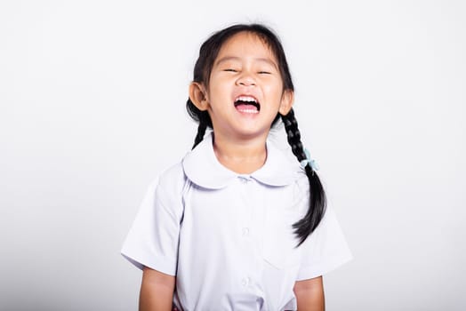 Asian adorable toddler smiling happy wearing student thai uniform red skirt standing in studio shot isolated on white background, Portrait little children girl preschool, Happy child Back to school