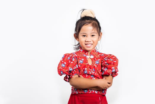Asian little kid 3 years old wearing a red shirt smiling with arms crossed at studio shot isolated on white background, Portrait of Happy confidence child girl lifestyle, Positive person