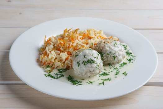 Plate with meatballs with rice and carrot.
