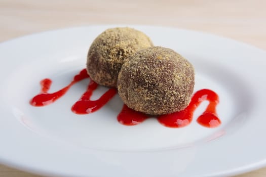 Chocolate truffles with biscuit powder. Rum balls and raspberry jam.