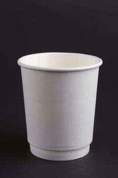 cardboard cup without lid on dark background